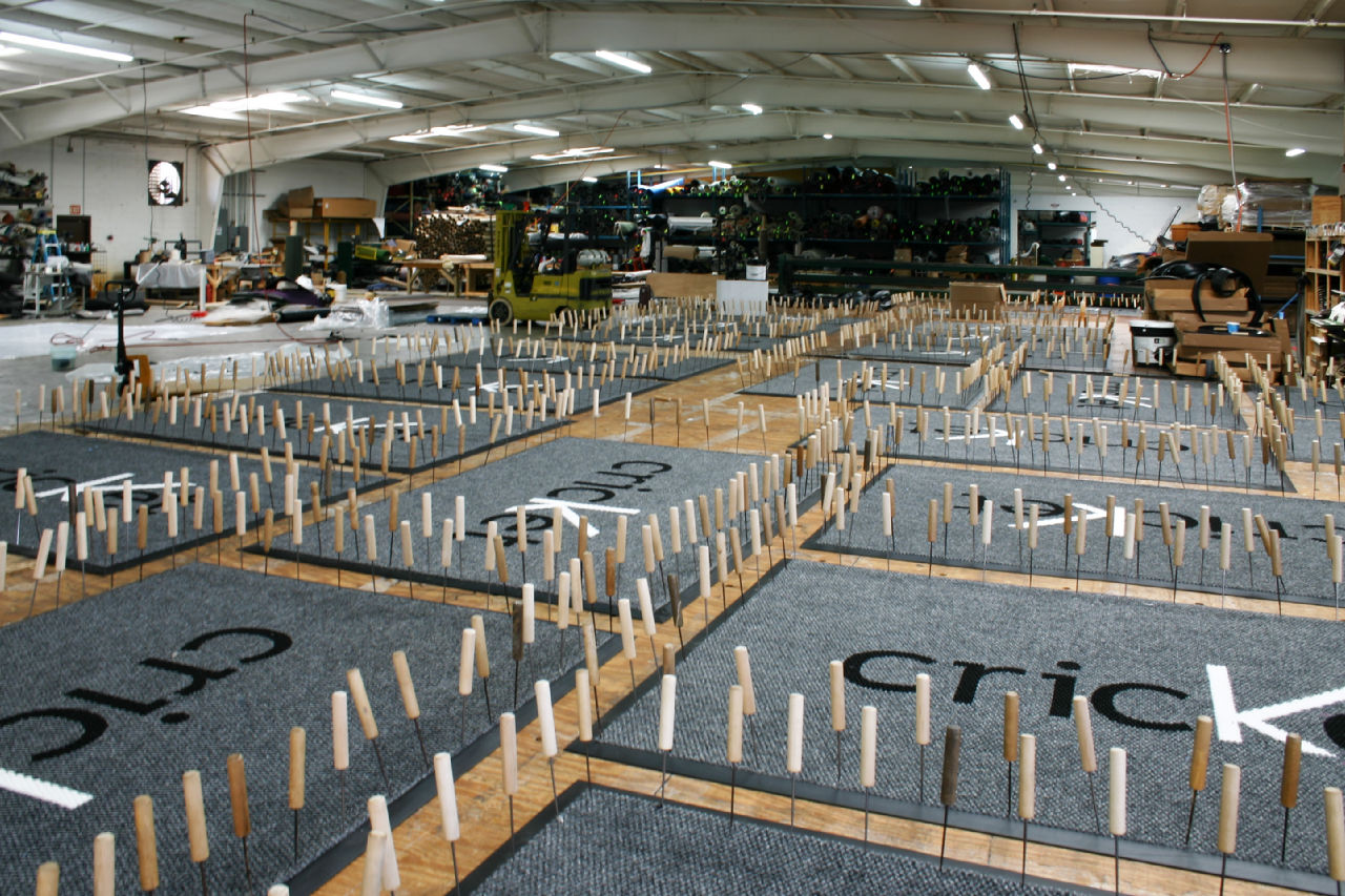 EcoPath sustainable entryway mats created for Cricket Communications stores wait to set at EcoPath’s manufacturing facility in Dalton, GA. Picks hold the mats in place to allow drying time for adhesives to lock into the soy-based backing. (Photo courtesy of EcoPath)