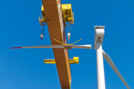 Installation of the second blade on the Vestas v80 wind turbine gets help from the Lisnave gantry crane.  (Photo courtesy Principle Power Inc.)