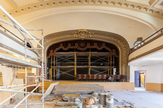 The auditorium along with its stage curtains, architectural moldings, and wood-backed chairs undergo a facelift and upgrade at Kelly Cullen Community. (Photo by Oliver Shay)
